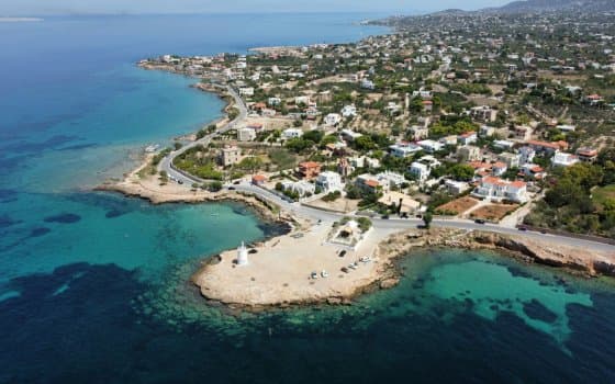 Aerial view of coastal town with turquoise waters in Greece