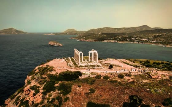 Temple of Poseidon on rocky cape with Aegean Sea view